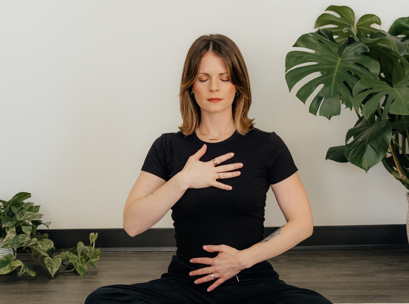 Jennifer Lancaster RYT-200 demonstrating breathwork and somatic awareness during trauma-informed yoga for eating disorder therapy in Houston