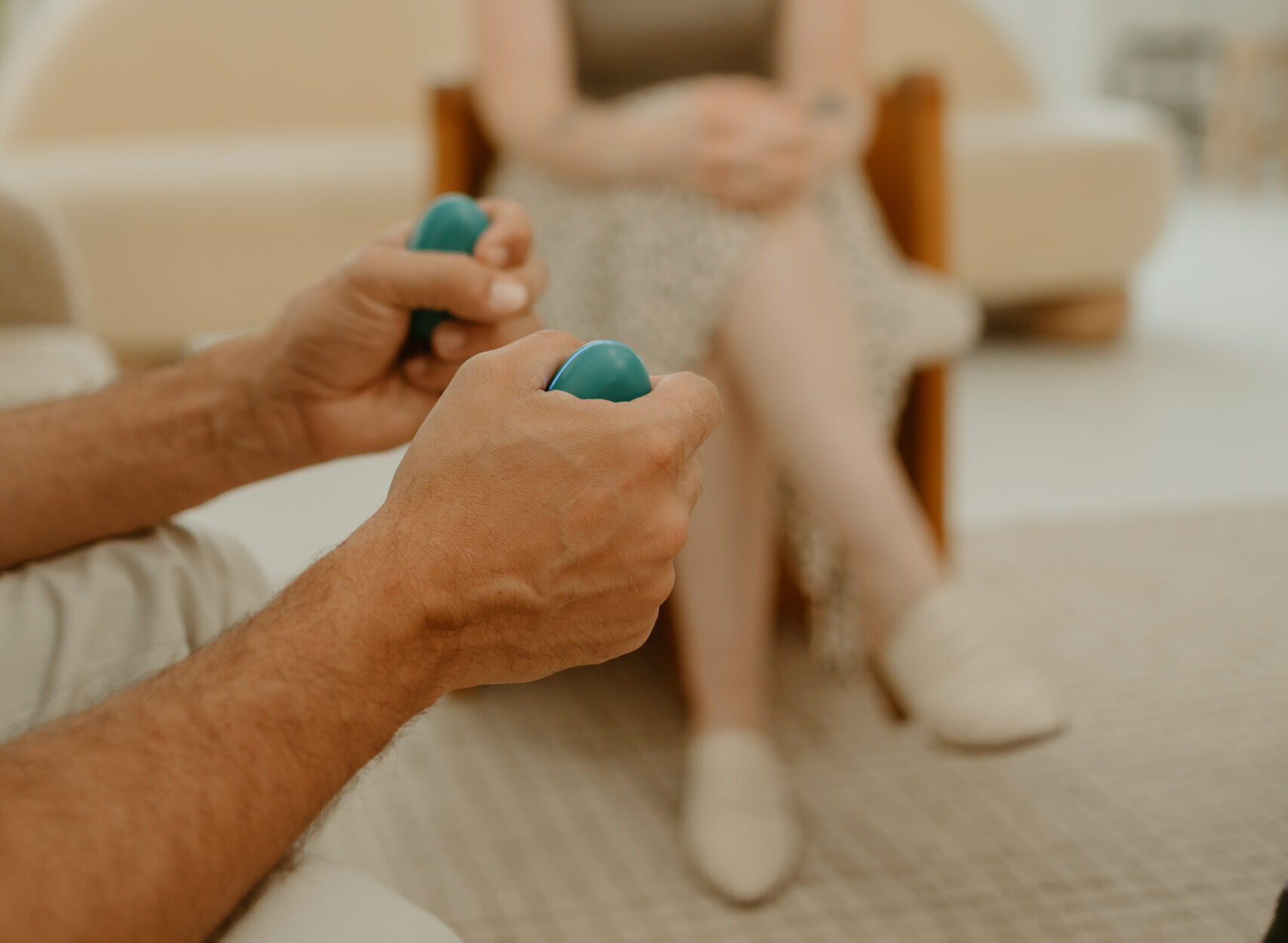 Person holding EMDR bilateral stimulation buzzers during a ketamine-assisted EMDR therapy session in Houston